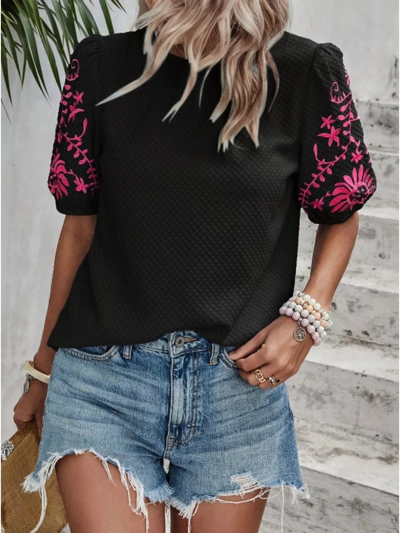 Black embroidered puff-sleeve blouse with pink floral embroidery on sleeves
