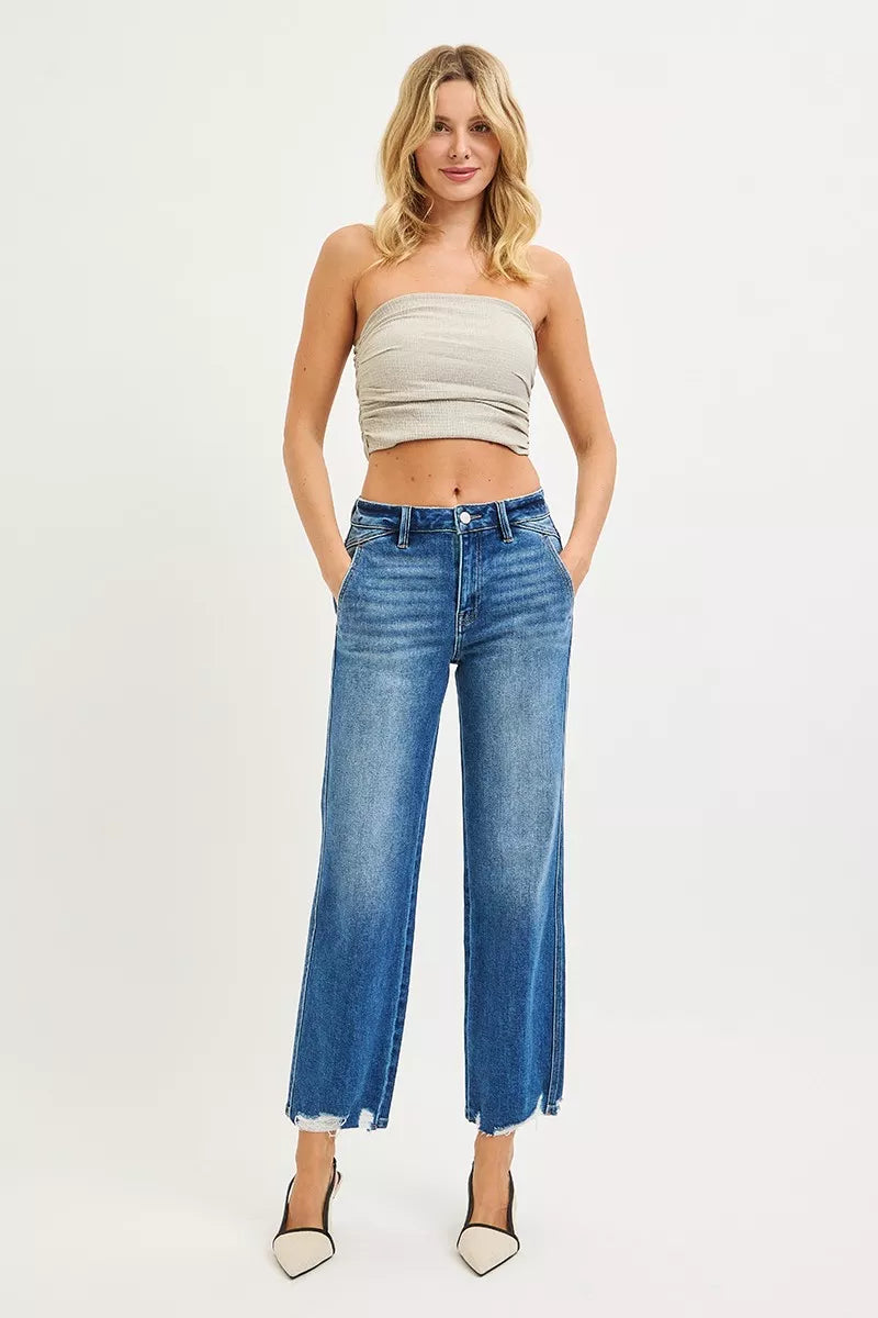 Medium wash high-rise straight jeans with frayed ankle hem
