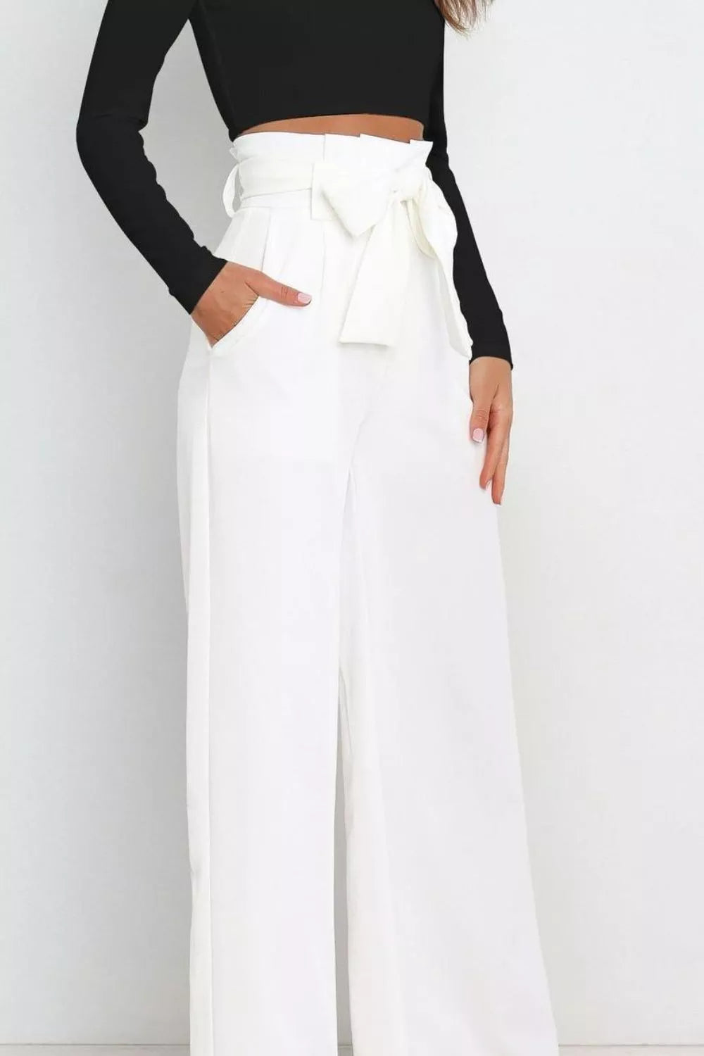 White high-waist wide-leg pants with front bow tie and draped waistband