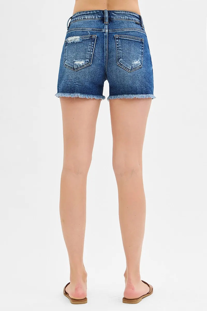 Back view dark denim low-rise shorts with patch pockets and frayed hem
