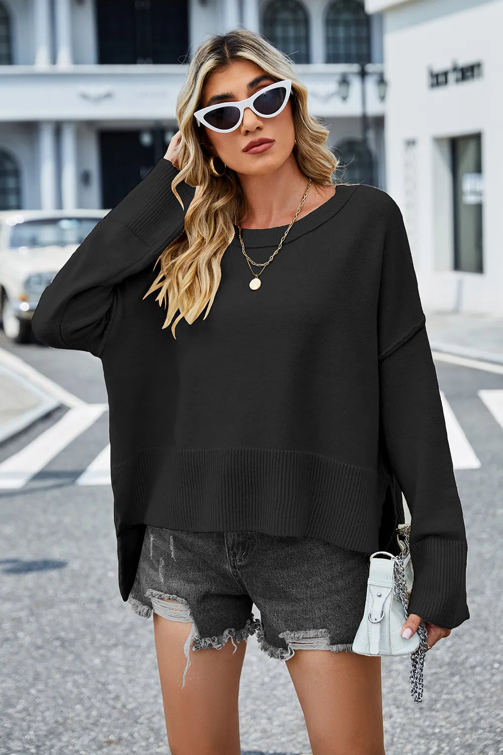 Black high-low slit sweater, round neck long sleeves, ribbed hem and cuffs