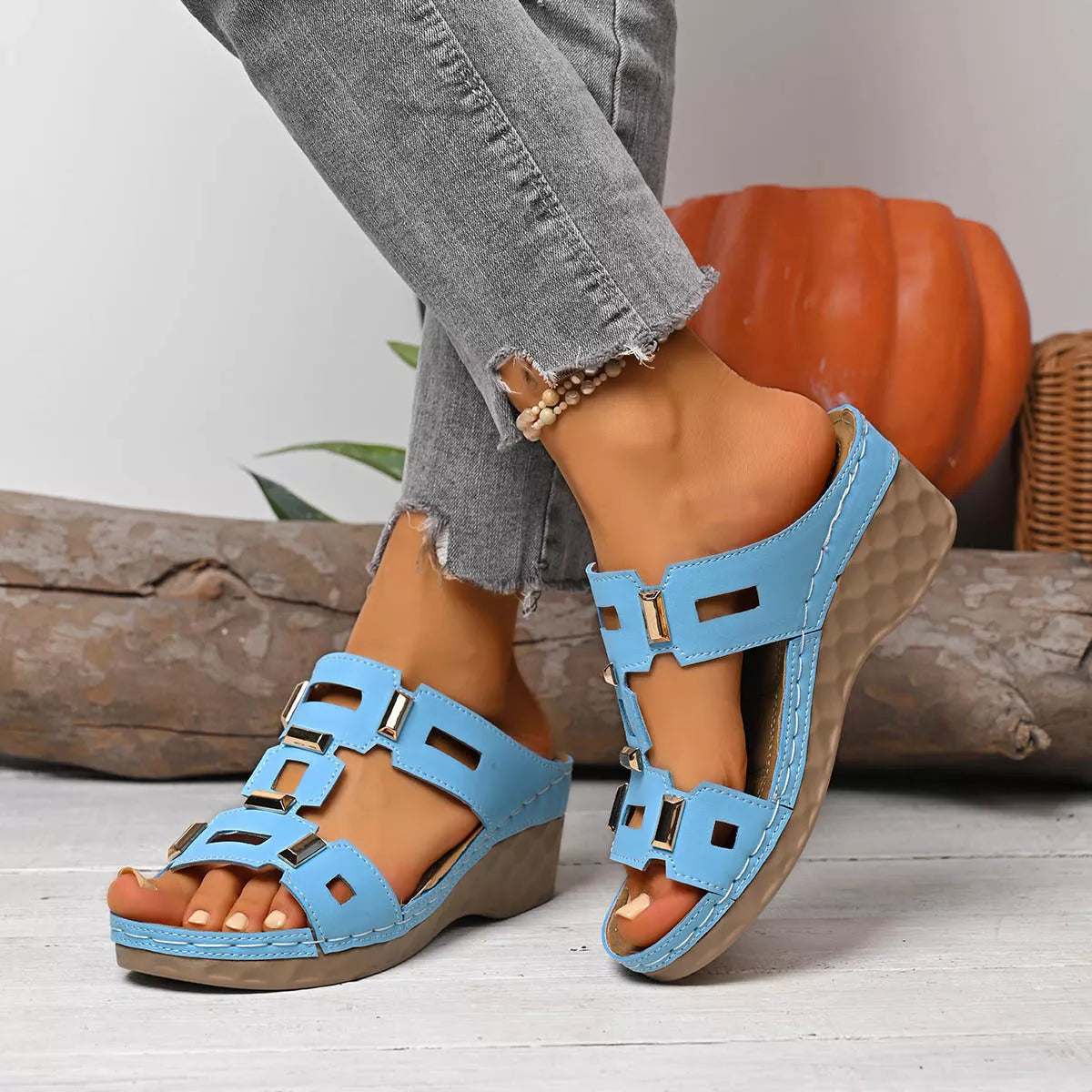 Open-toe wedge sandal in sky blue with chunky buckle straps and textured wedge