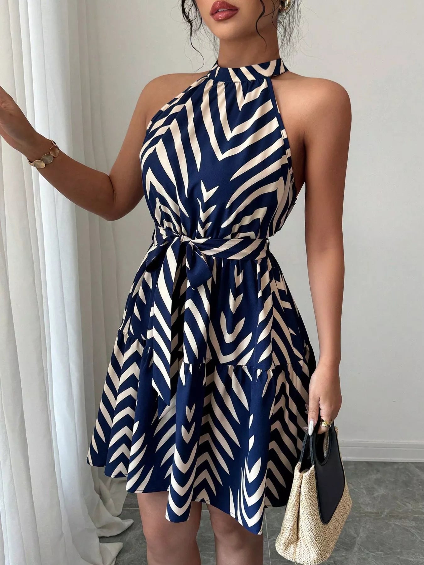 Blue zebra-print halter dress with tie waist and ruffle hem, swingy flared skirt