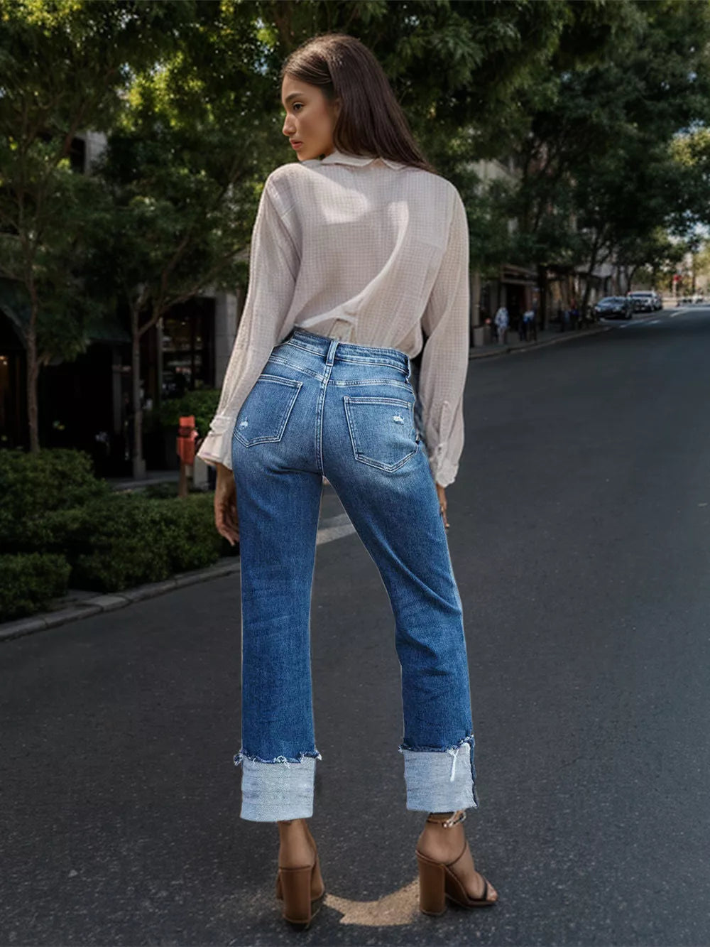 Medium blue straight jeans with rolled raw hem, back pockets, belt loops