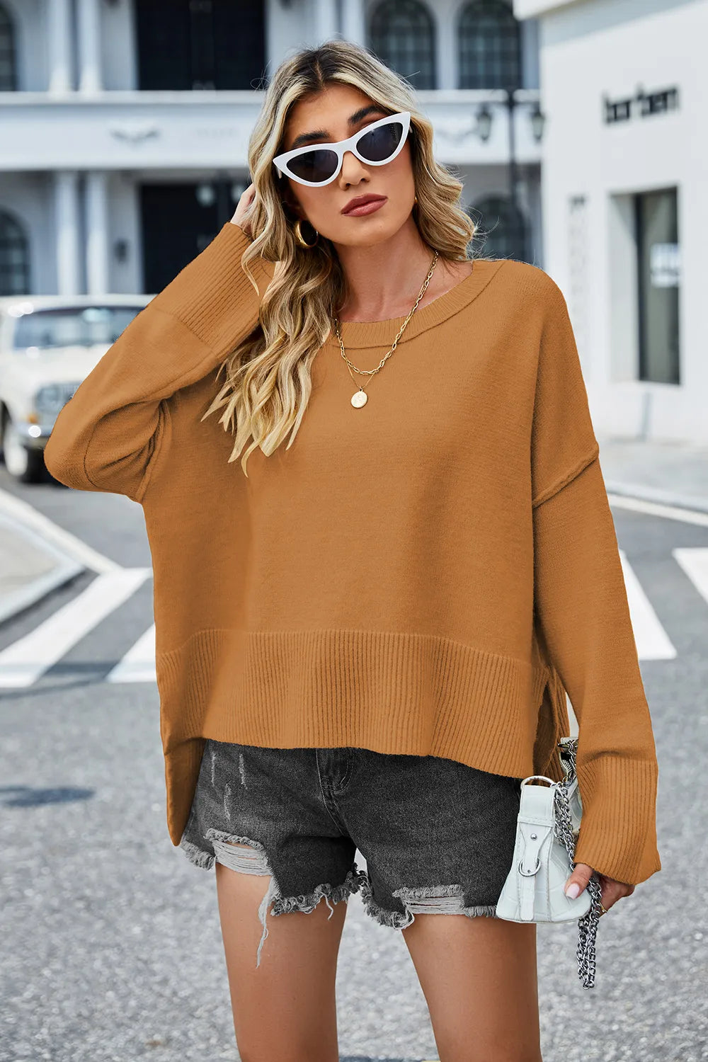 Caramel long-sleeve knit sweater with round neckline; ribbed bottom and side slit hem