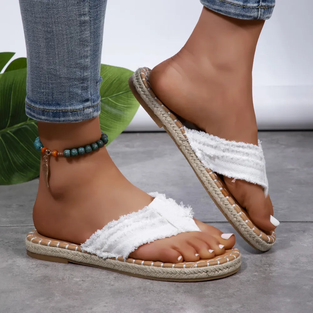 White toe-post flat sandals with frayed cross strap and tan jute-look sole
