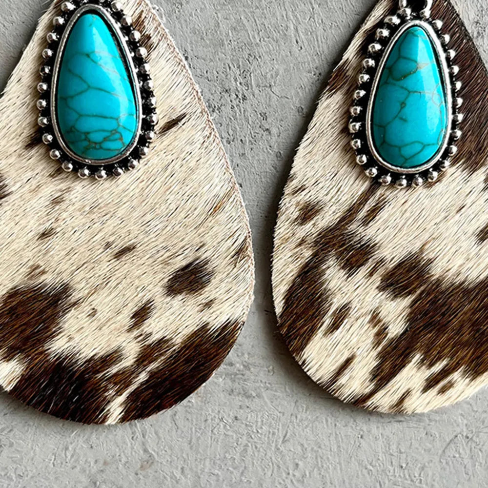 Teardrop earrings with turquoise cabochon and silver studs on cowhide-pattern dangles