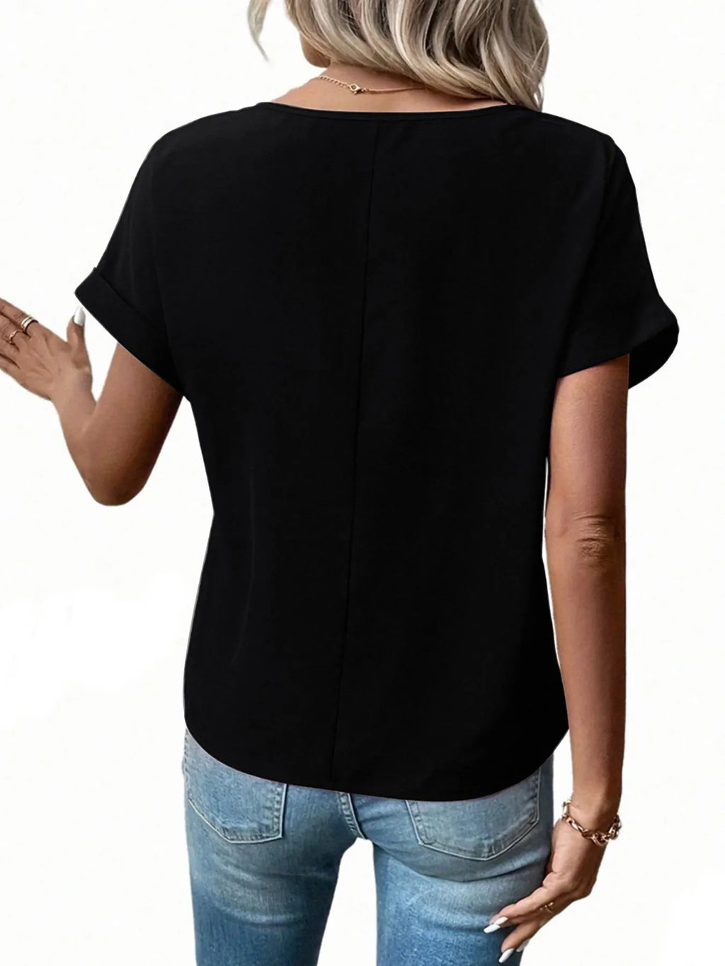 Back view of black short-sleeve zipper blouse with center seam detail