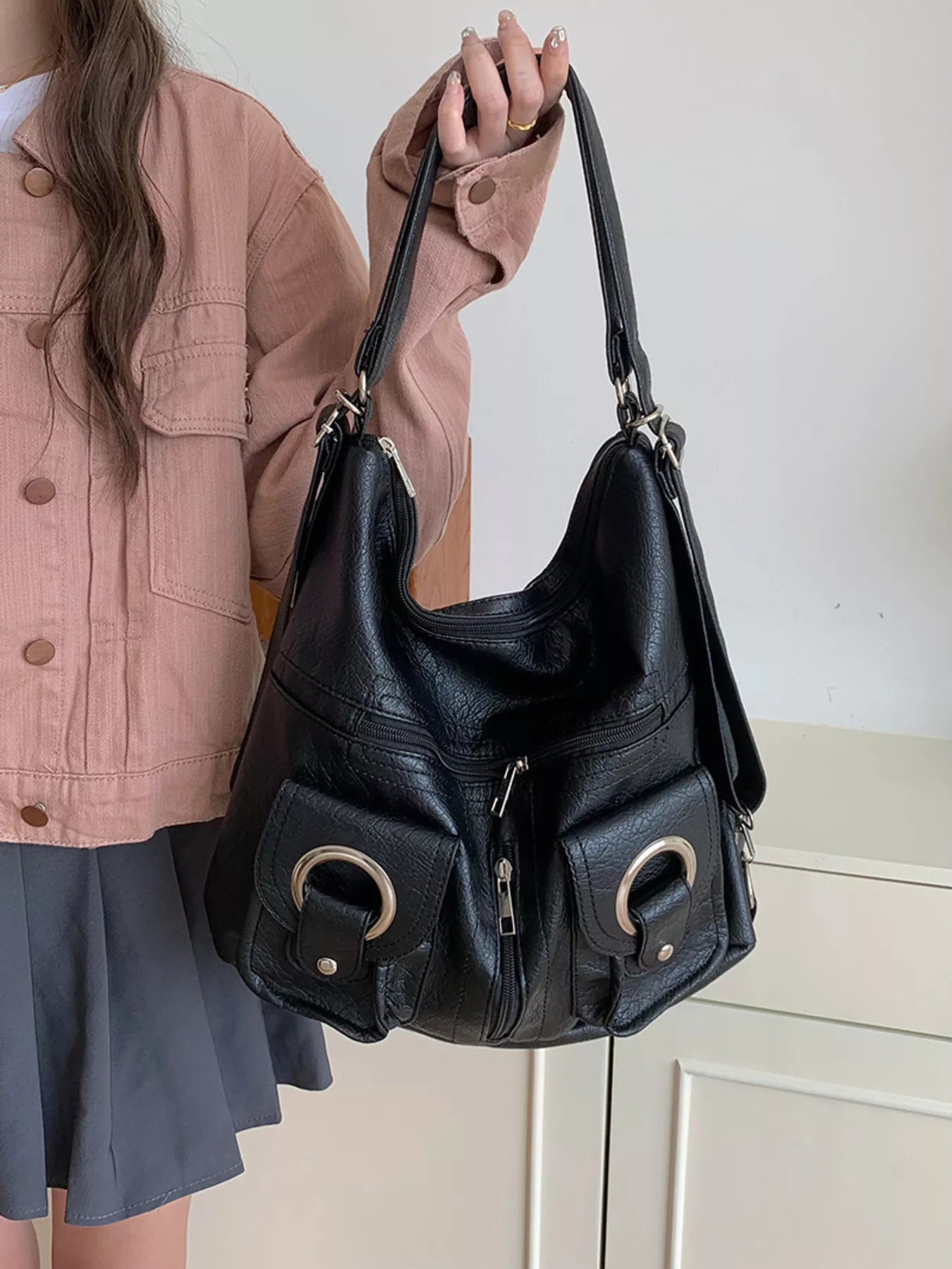 Convertible pocket handbag, black; front dual ring buckles and zip pocket detail