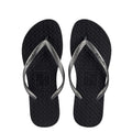 Black toe-post flat sandals with textured thong straps and V-shaped sole