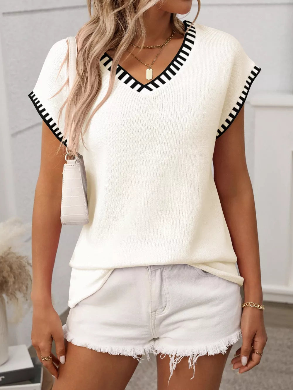 Cream knit V-neck short-sleeve top with black contrast trim