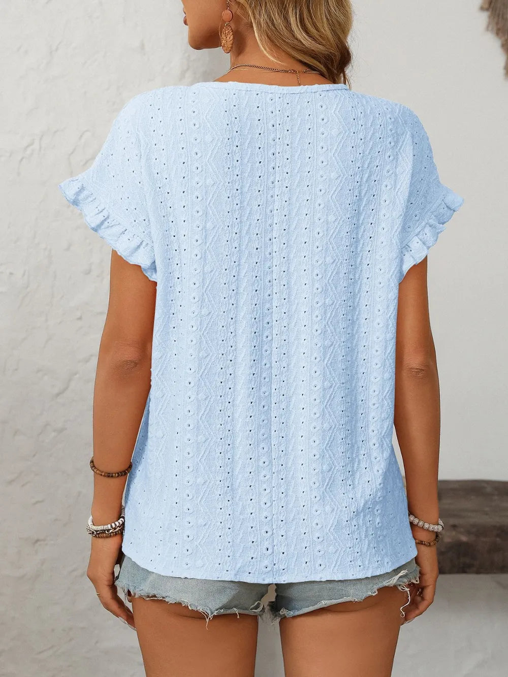 Light blue eyelet round-neck short sleeve top with flutter cuffs, back view.