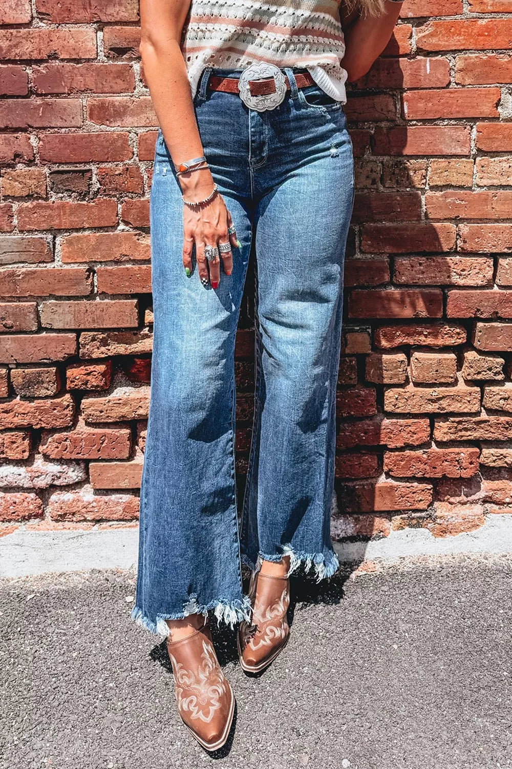High-waist flare jeans in medium wash denim with frayed hem
