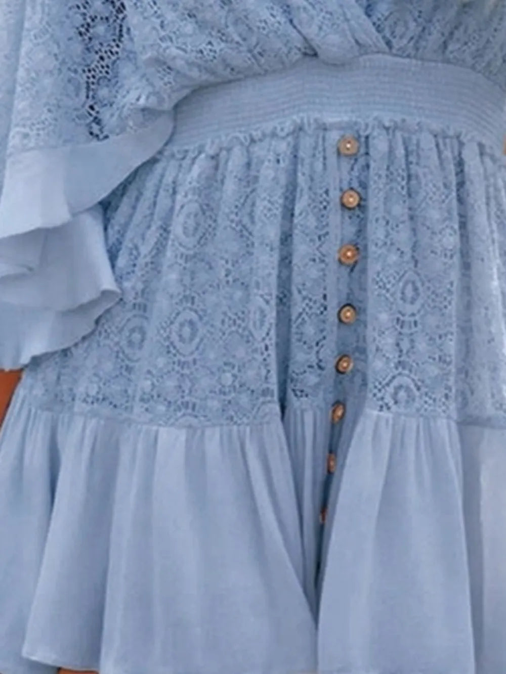 Light blue lace mini dress close-up of tiered skirt and front button detail