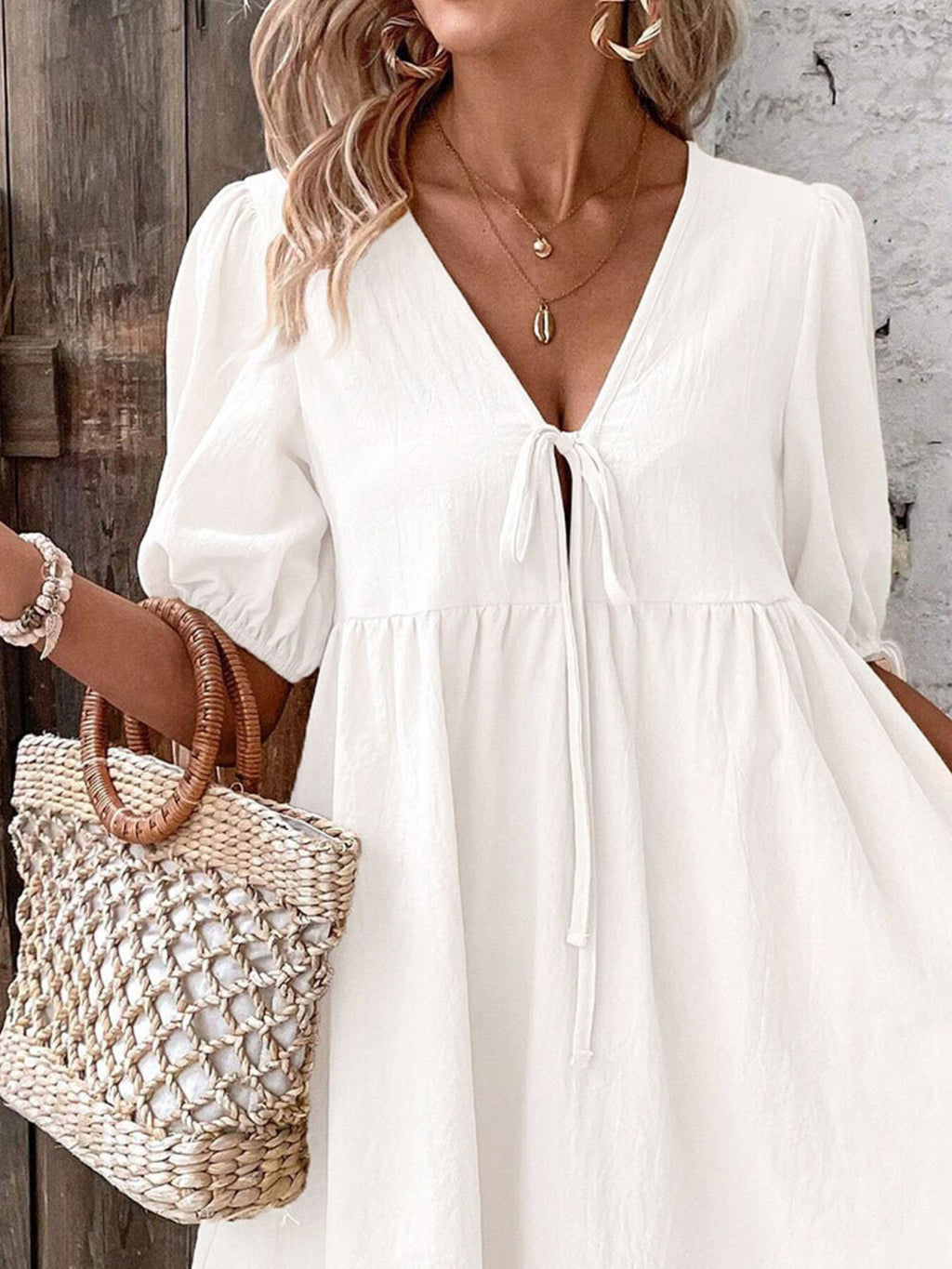 White V-neck mini dress with tie front and puff sleeves