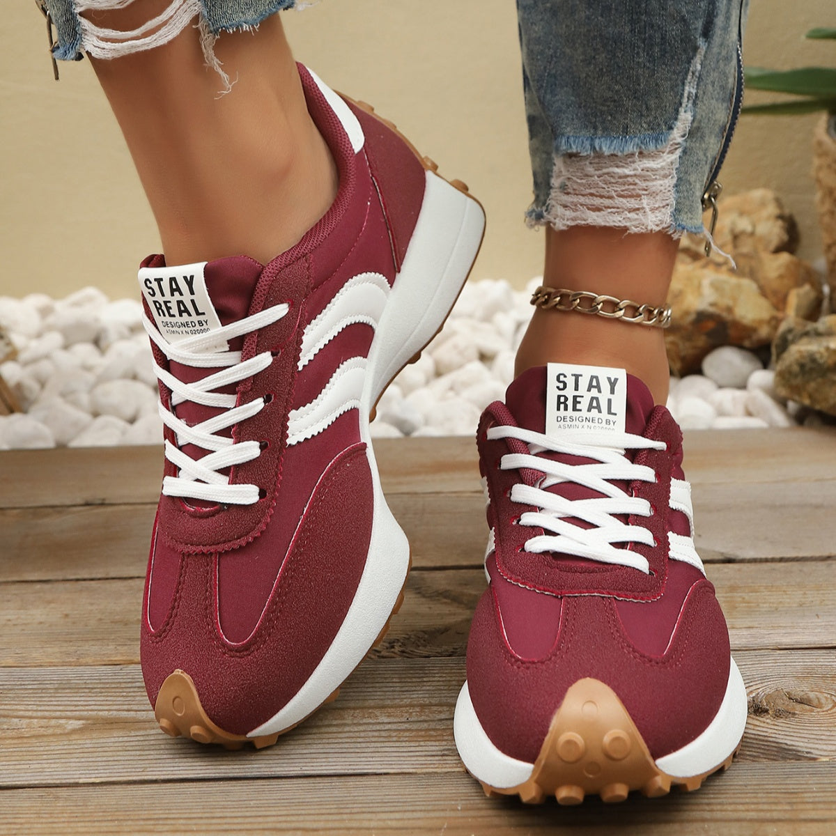 Burgundy lace-up sneakers with white striped panels, round toe, tan traction outsole