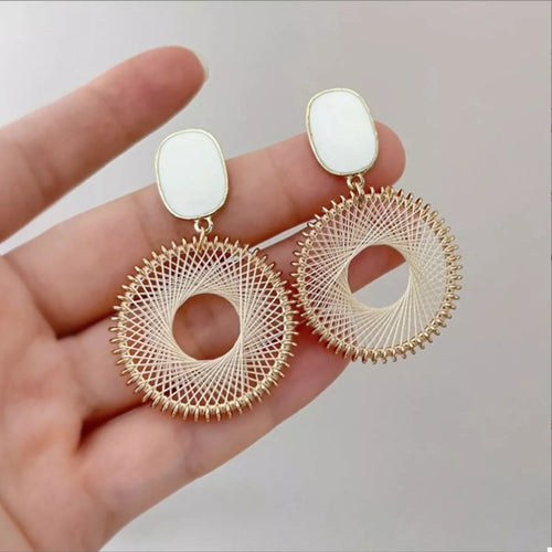 Gold-plated circle dangle earrings with white oval tops and woven ring with center hole