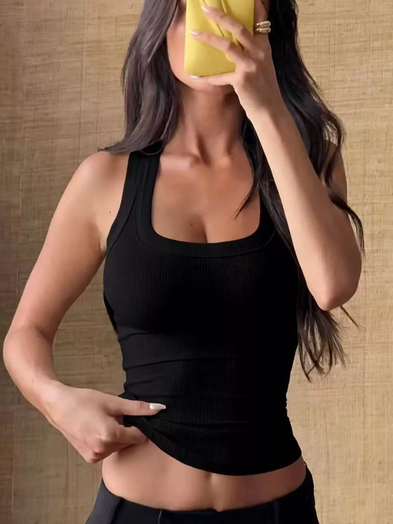 Black ribbed knit slim fit tank with scoop neckline, fitted through waist