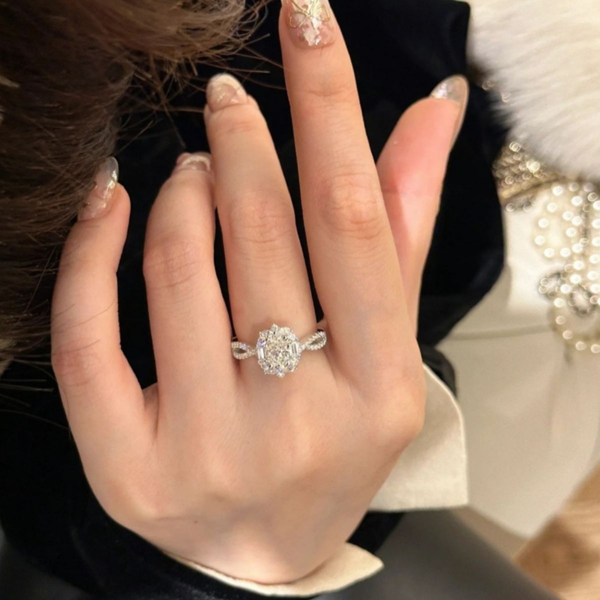 Sterling silver moissanite halo ring worn on hand, large oval center with sparkle