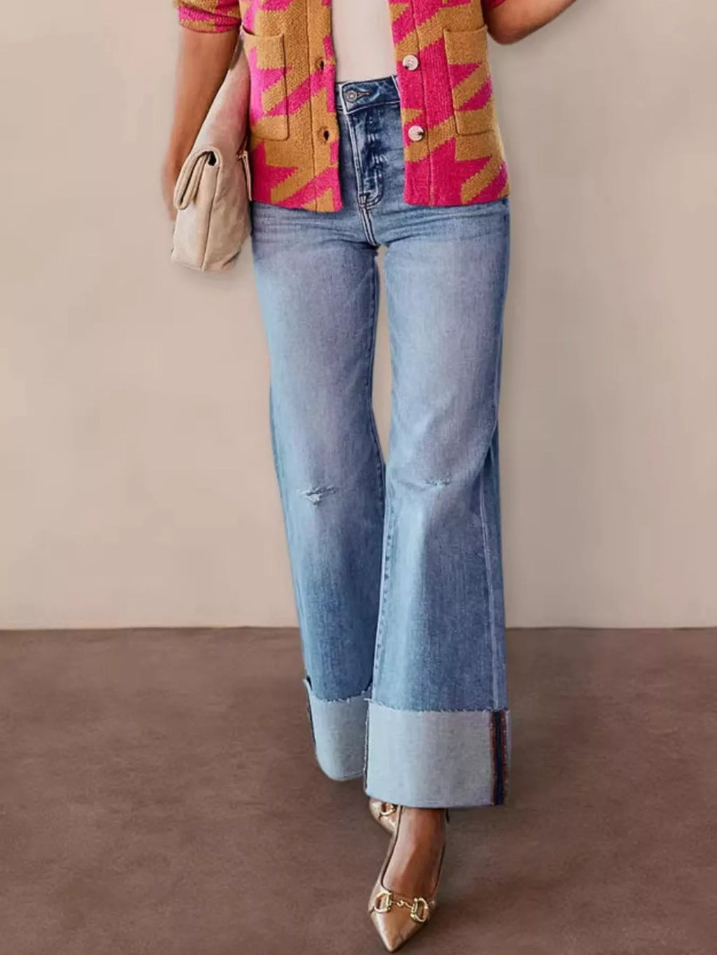Light blue distressed high-waisted flare jeans with button fly and frayed hem