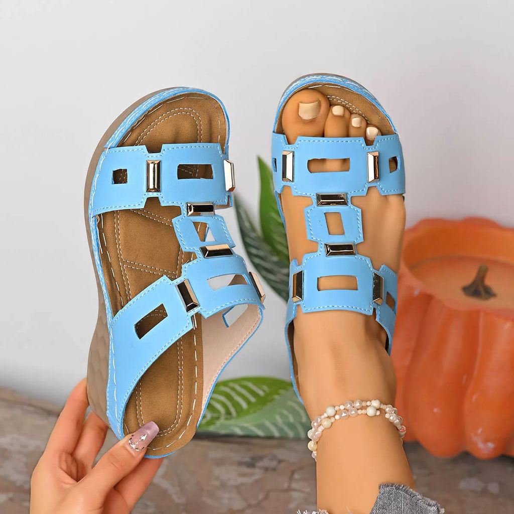Open-toe wedge sandal in sky blue with cutout buckle straps and cushioned footbed