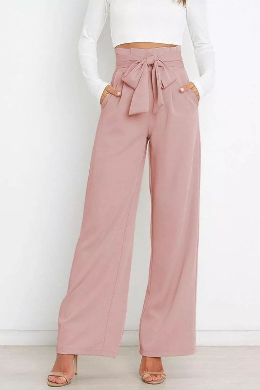 Blush pink high-waist tie-front wide-leg pants with tied bow at the center waist