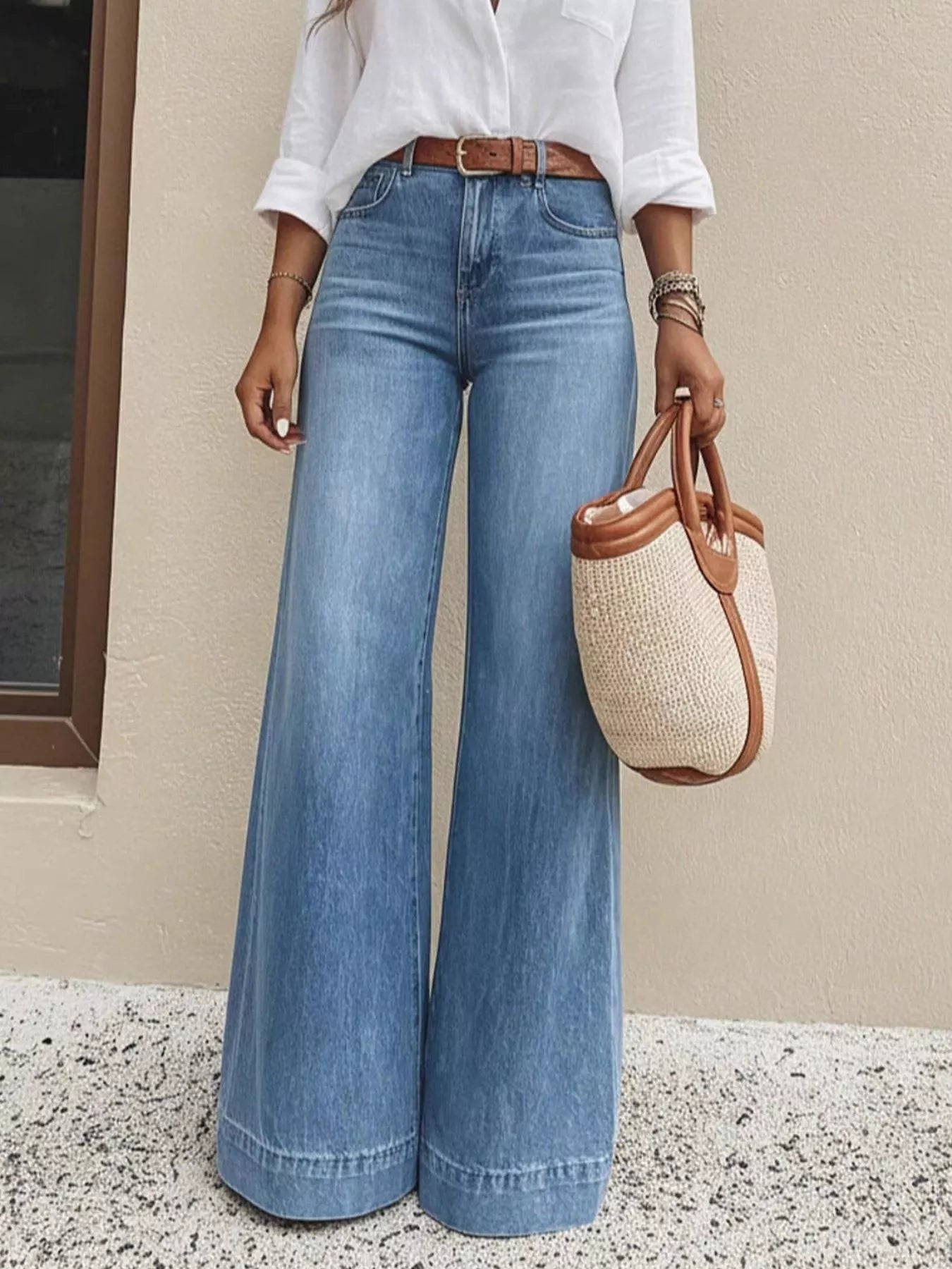 Front view high-waisted wide-leg denim jeans, light blue wash, belt loops, front pockets