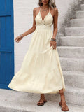 Light yellow halter maxi dress with layered tiers and beaded trim bodice