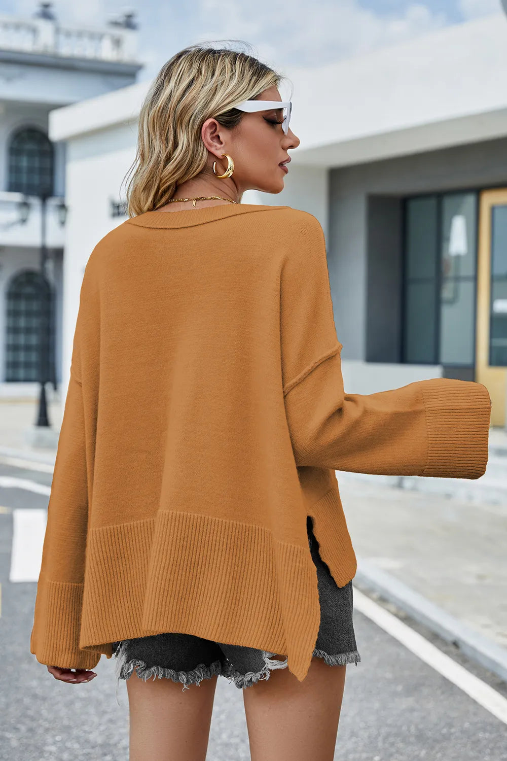 Caramel sweater back view, long sleeves with ribbed cuffs; high-low hem slit