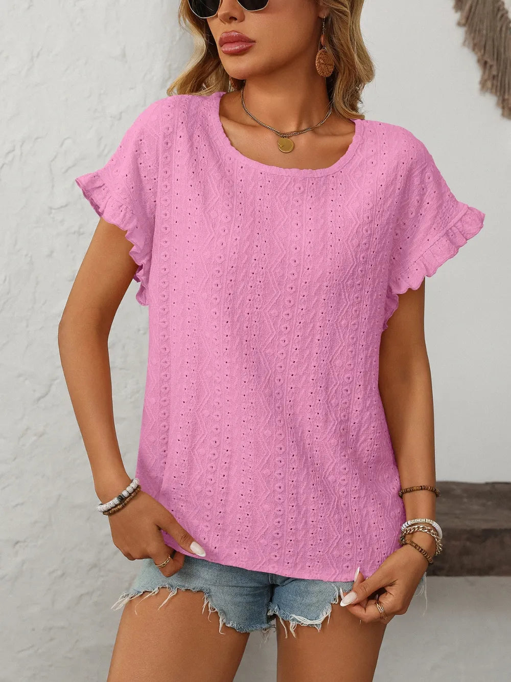 Fuchsia pink eyelet short-sleeve top with round neck and embroidered dot diamond texture