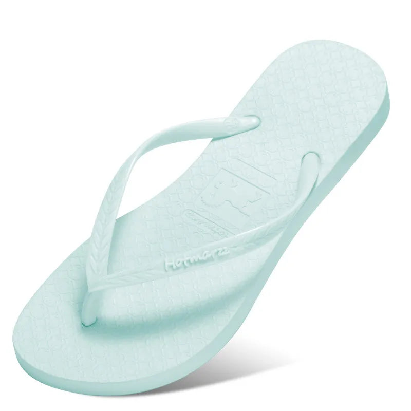 Light blue toe-post flat sandals with textured footbed and thong strap