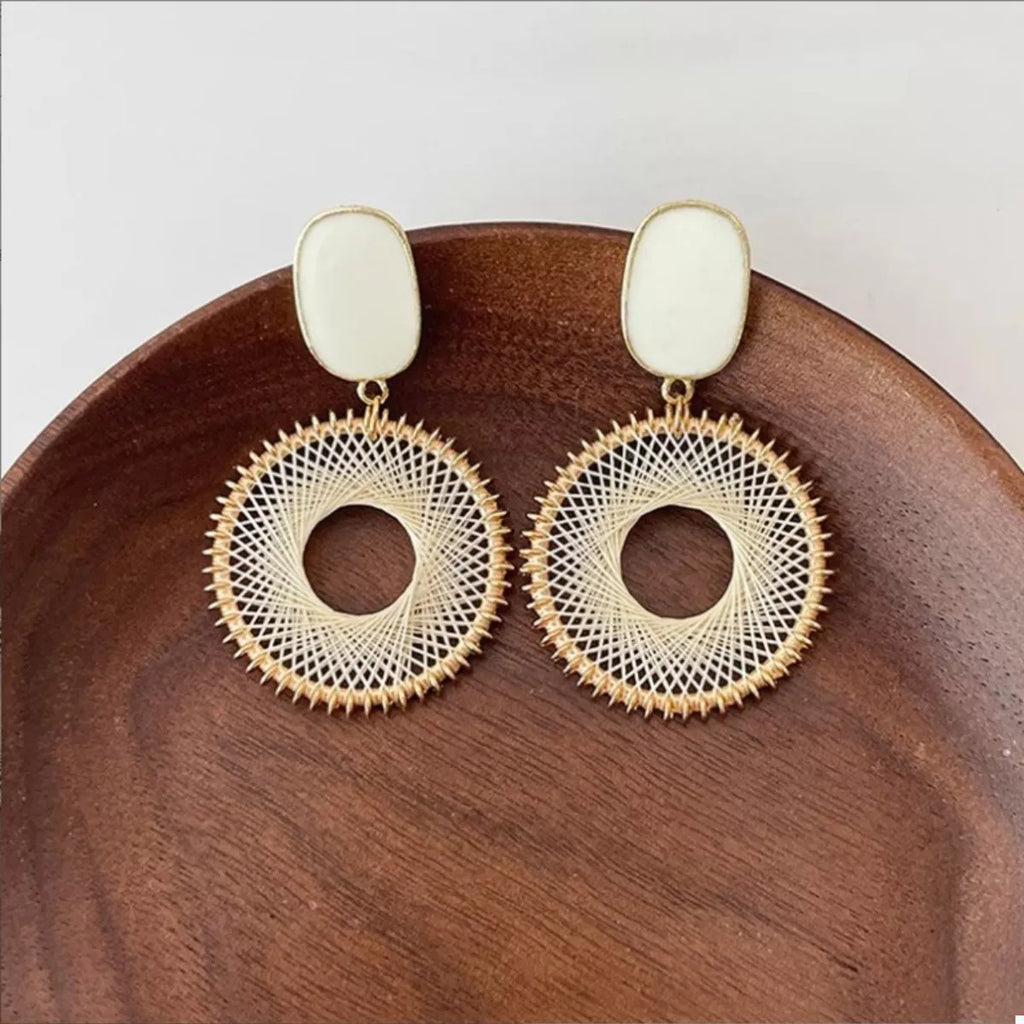 Gold-plated circle dangle earrings featuring white oval studs and gold woven hoop rings
