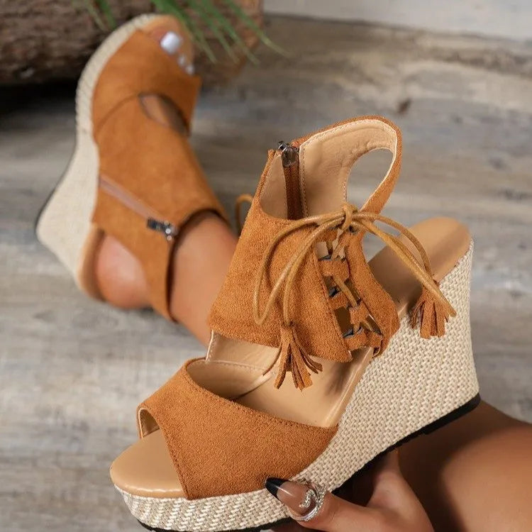 Rust orange peep-toe wedge sandals with ankle tie laces, tassels, and platform heel
