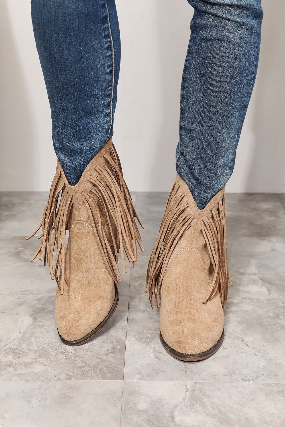 Khaki suede ankle boots with fringe and stacked heel, western cowboy style