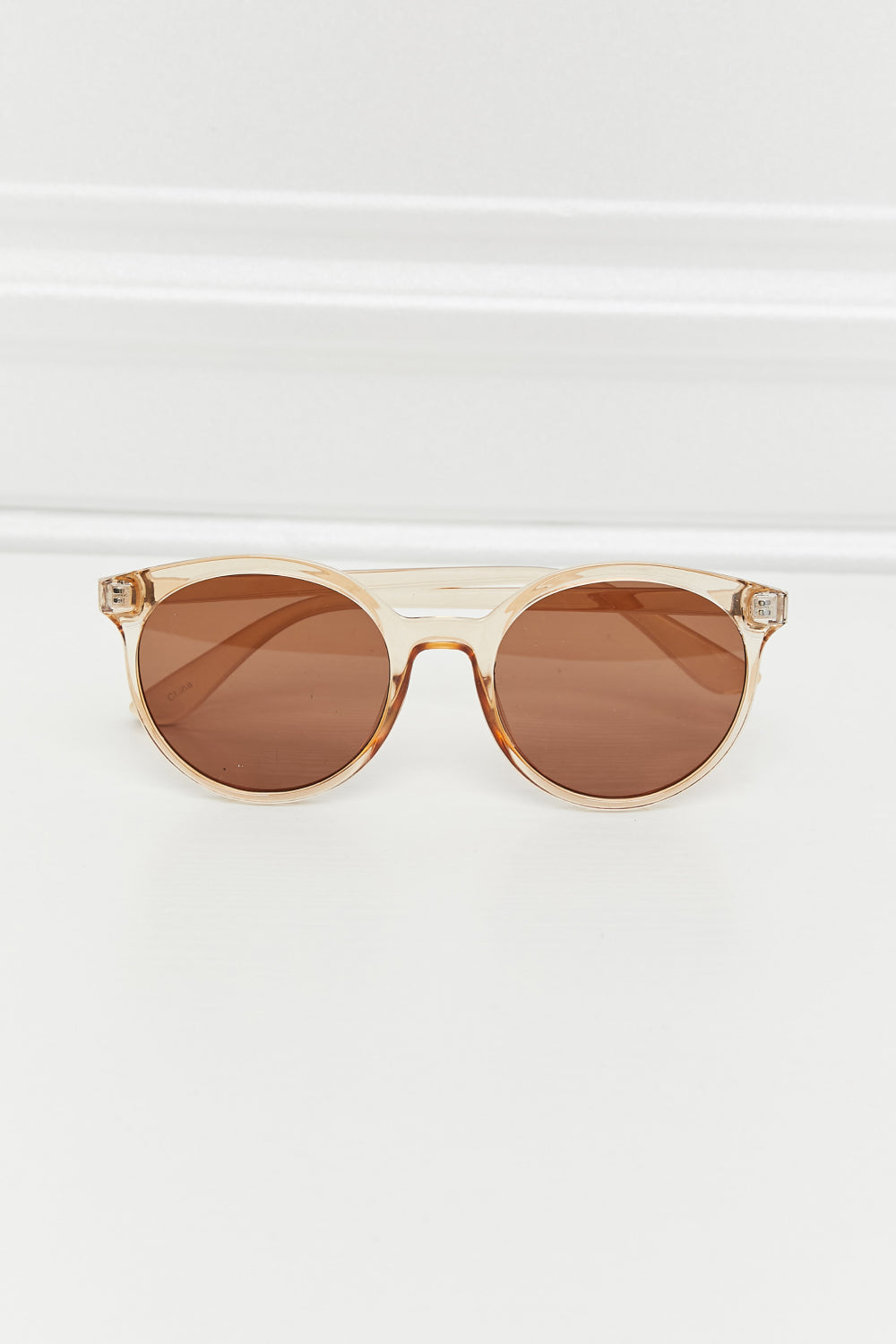 Front view tan round sunglasses with brown lenses and full-rim polycarbonate frame