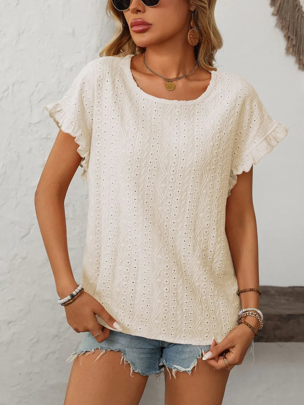White eyelet short-sleeve top with round neck and eyelet embroidery texture