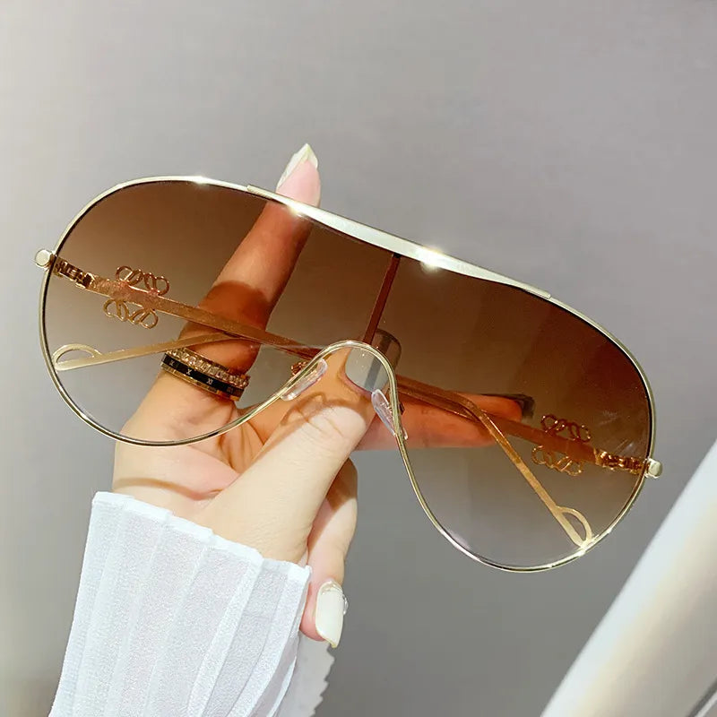 Aviator sunglasses with gold-tone frame and gradient warm brown lenses