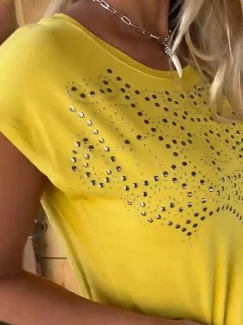Yellow T-shirt with studded heart pattern and fringe hem at the bottom edge