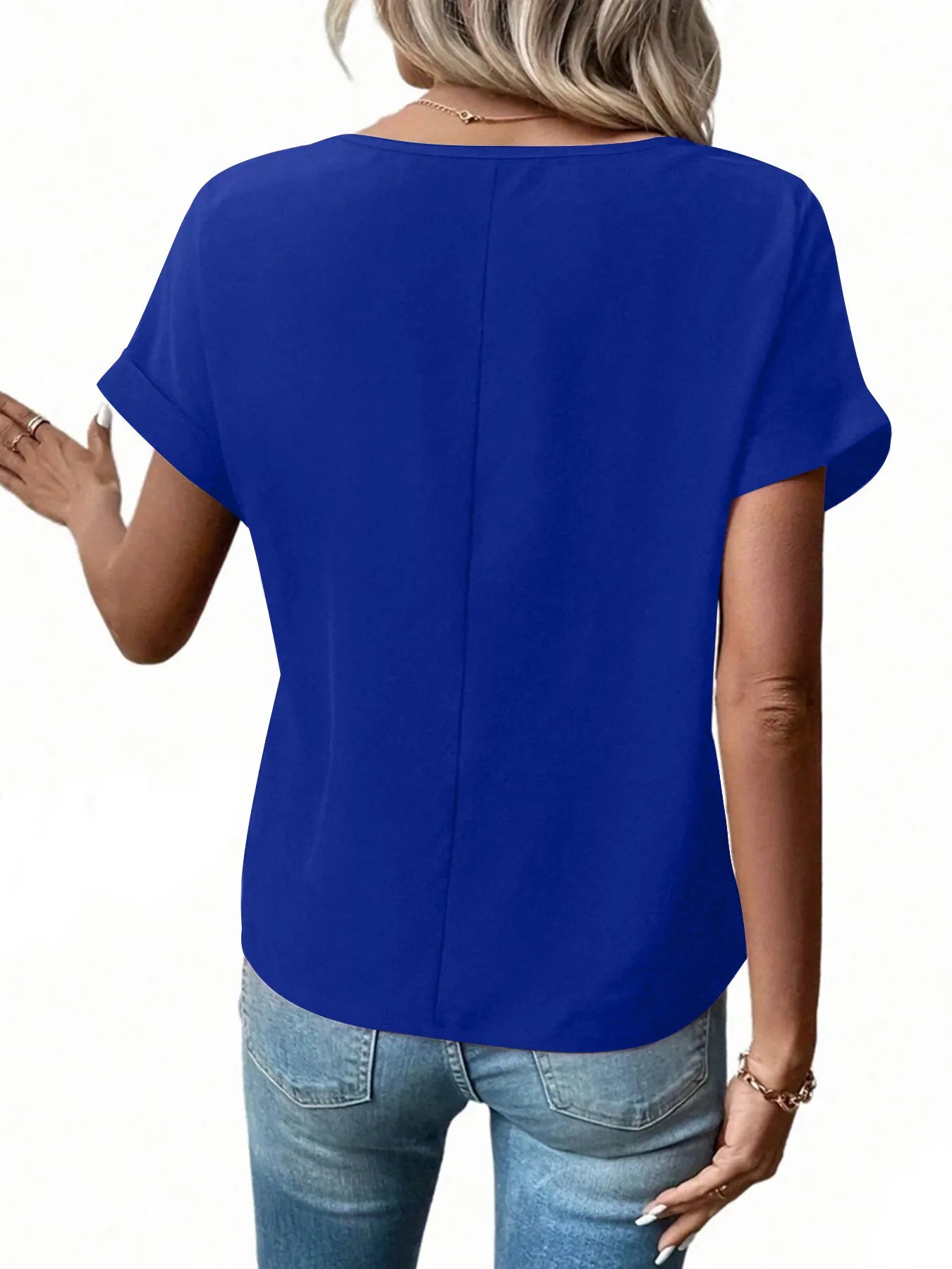 Back view of blue short-sleeve zip blouse with curved hem