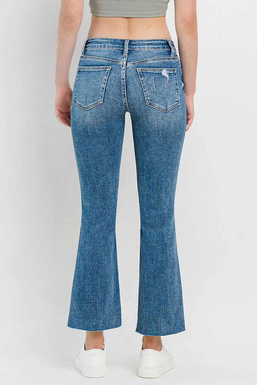 Medium-blue mid-rise flare jeans with back patch pockets and clean dark whiskering
