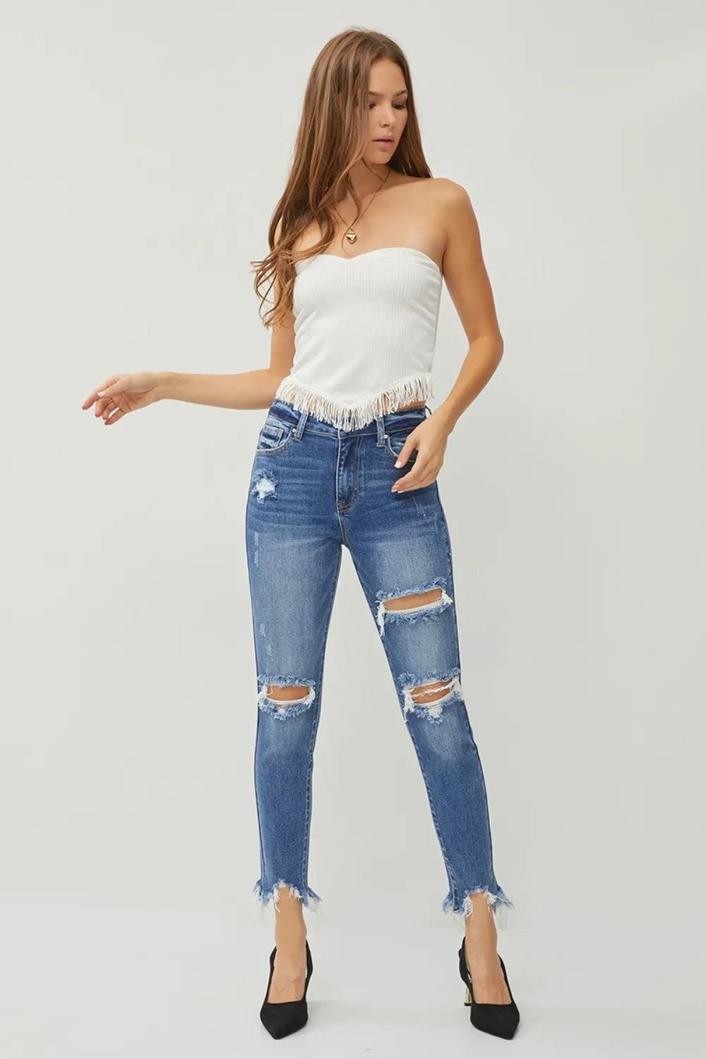 Dark wash slim jeans with thigh rips and frayed ankle hem