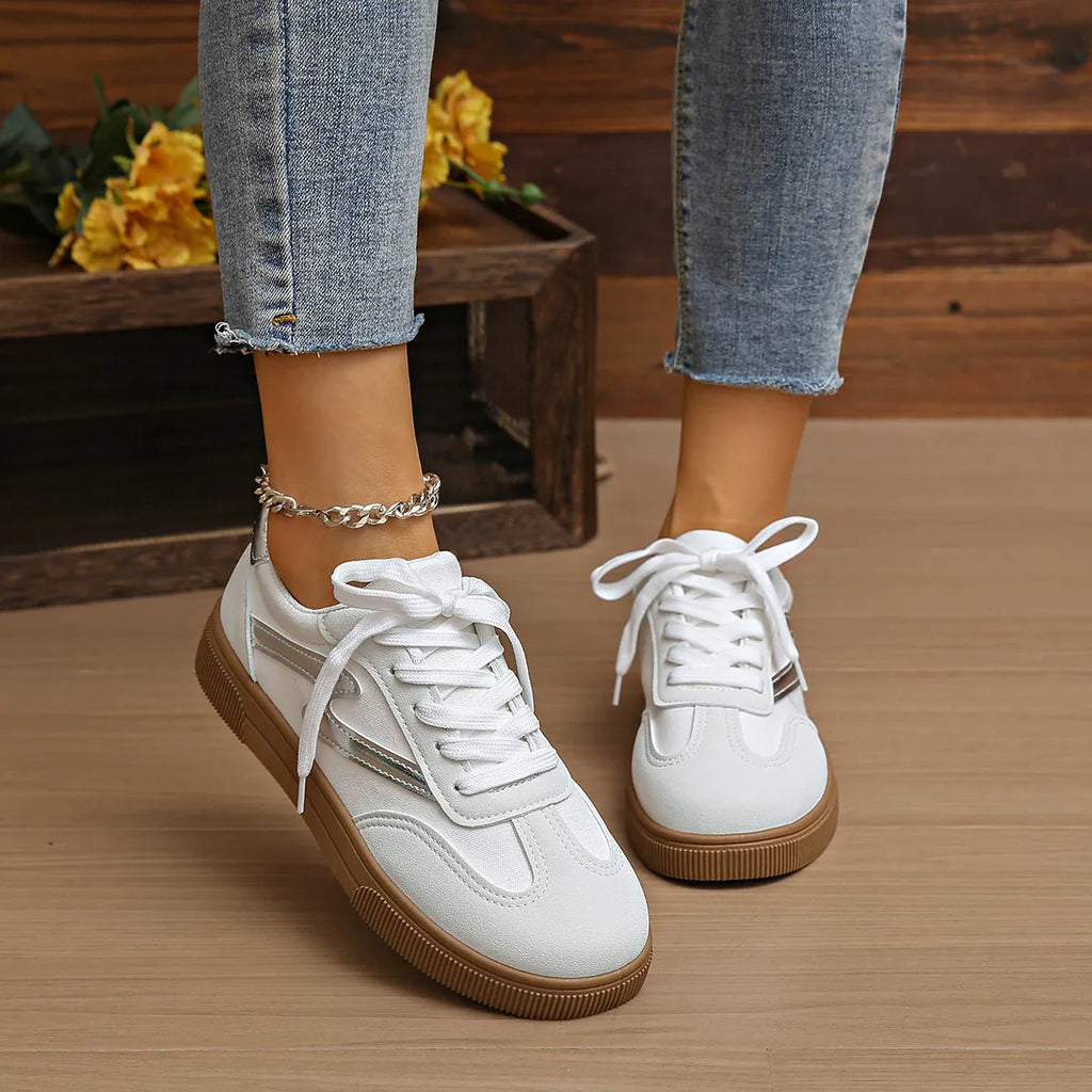 White lace-up sneakers, white laces and tan ribbed sole