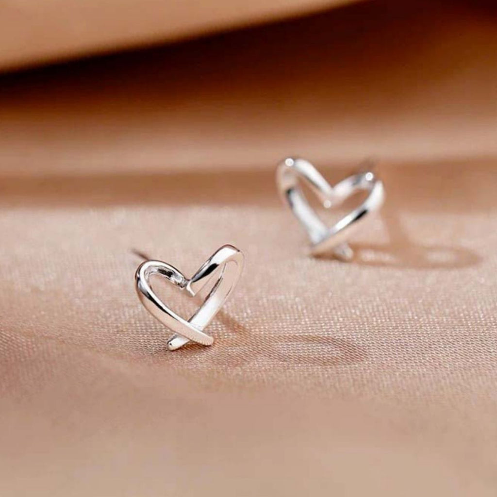 Silver heart-shaped stud earrings with glossy heart outline