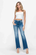 Medium-wash straight jeans with distressed rips and raw hem, mid-rise fit