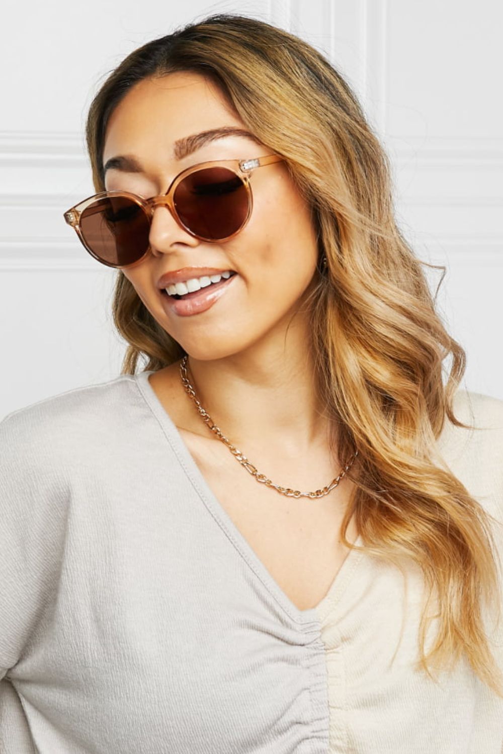 Tan round sunglasses with brown lenses and thin gold-tone full frame