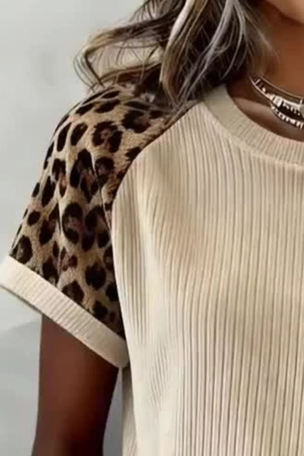 Beige ribbed tee front with leopard-pattern raglan sleeves