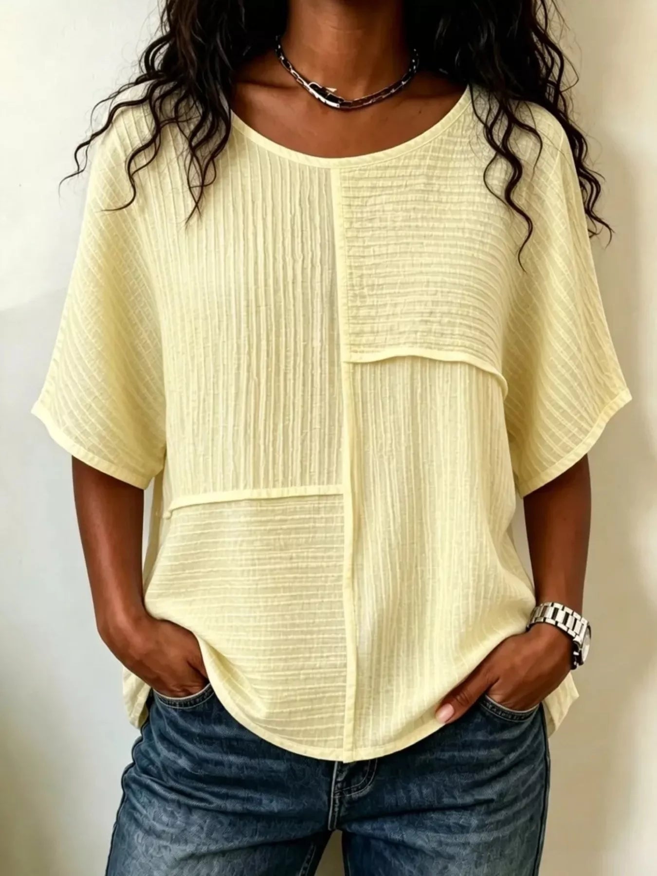 Light yellow textured round-neck half-sleeve blouse with vertical seam panel detail