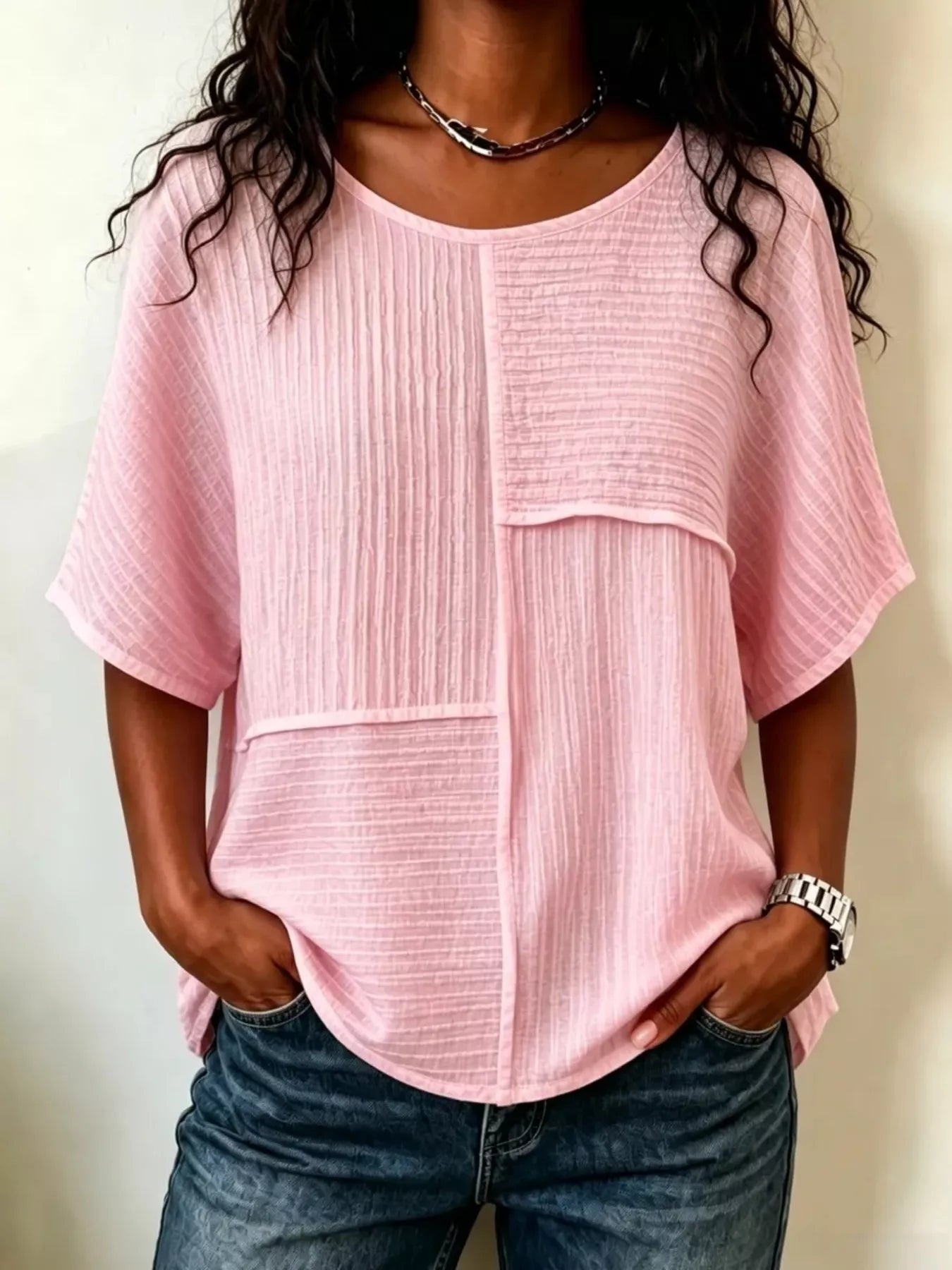 Pink textured round-neck half-sleeve blouse with vertical seam panel detail