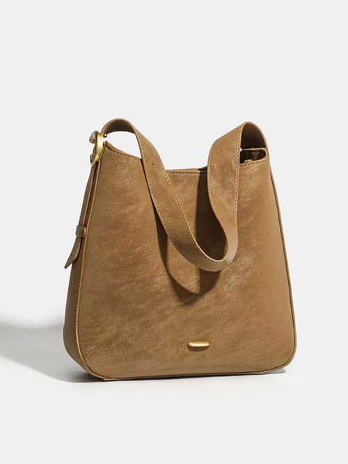 Brown faux leather shoulder bag with long shoulder strap and gold-tone hardware