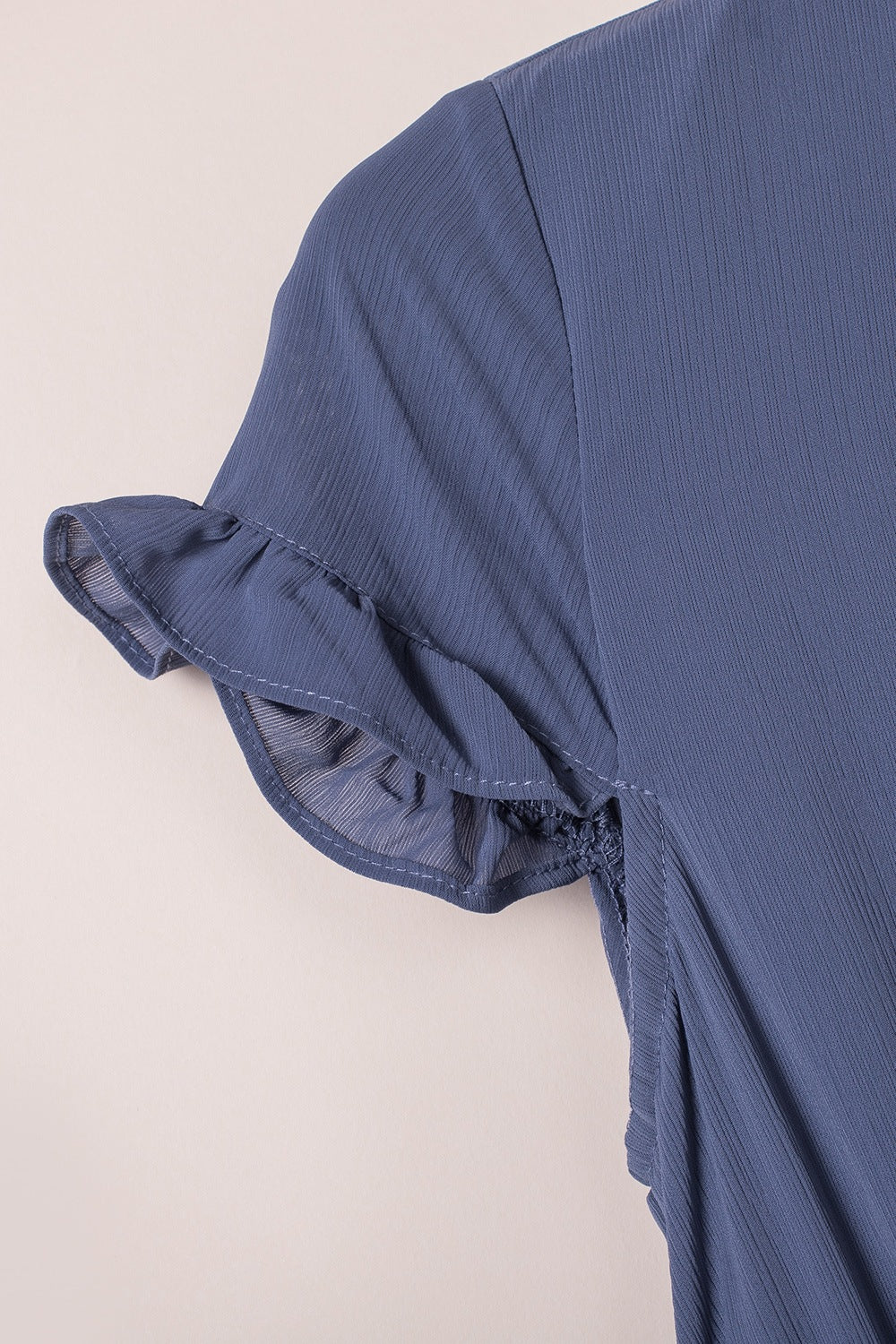 Dusty blue ruched sleeve with layered ruffle detail